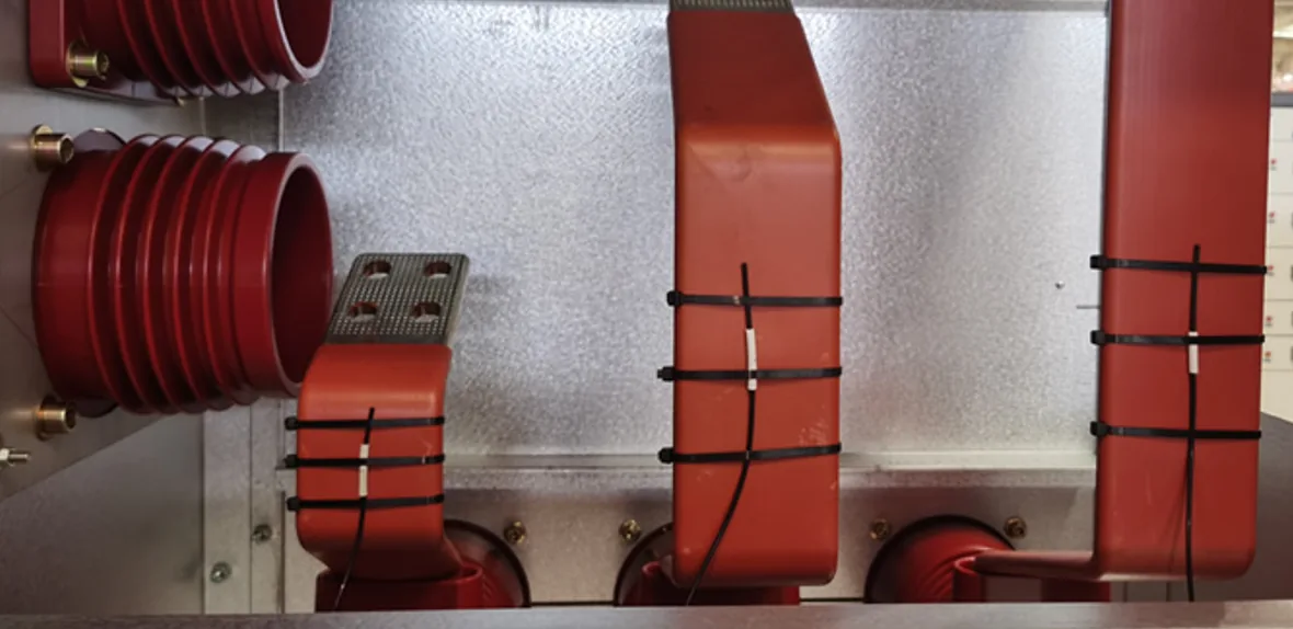 Fiber optic temperature probes mounted on high-current busbar connection points inside electrical equipment